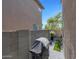 Paver patio with a black grill, bordered by a brick wall and nearby foliage at 5439 W Odeum Ln, Phoenix, AZ 85043