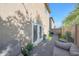Backyard patio area with brick pavers, outdoor seating, and a charming garden at 5439 W Odeum Ln, Phoenix, AZ 85043