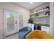 Cozy bar area with wine fridge, decorative shelves, and outdoor access through double glass doors at 5439 W Odeum Ln, Phoenix, AZ 85043
