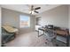 Bedroom featuring neutral walls, a ceiling fan, a built-in desk, and wood look flooring at 5439 W Odeum Ln, Phoenix, AZ 85043