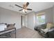 Bedroom featuring neutral walls, a ceiling fan, natural light and wood look flooring at 5439 W Odeum Ln, Phoenix, AZ 85043