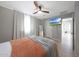 Bedroom featuring neutral walls, a ceiling fan, and wood look flooring, with access to an ensuite bathroom at 5439 W Odeum Ln, Phoenix, AZ 85043