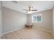 Neutral bedroom featuring laminate floors, a modern ceiling fan, and bright, natural light at 5439 W Odeum Ln, Phoenix, AZ 85043