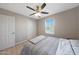 Bedroom featuring neutral walls, a ceiling fan, a double bed, and wood look flooring at 5439 W Odeum Ln, Phoenix, AZ 85043
