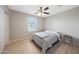 Bedroom featuring neutral walls, a ceiling fan, a double bed, and wood look flooring at 5439 W Odeum Ln, Phoenix, AZ 85043