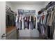 Walk-in closet featuring a hanging clothes and shelving, with wood look flooring at 5439 W Odeum Ln, Phoenix, AZ 85043