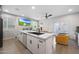 Bright open-concept kitchen featuring a marble island, stainless appliances, and a dining area with plenty of seating at 5439 W Odeum Ln, Phoenix, AZ 85043