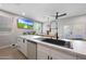 Modern kitchen with island sink, and stainless steel appliances, with an eat-in dining area at 5439 W Odeum Ln, Phoenix, AZ 85043