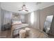 Bedroom featuring neutral walls, decorative wall art, natural light, and wood look flooring at 5439 W Odeum Ln, Phoenix, AZ 85043