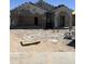 Under construction: a single-Gathering home shows exposed stucco, a two-car garage, and arched porch, ready for personalization at 6015 E Artemis Dr, Florence, AZ 85132