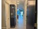 Entryway showcasing modern light fixture, display cabinet, and view to living area at 7120 E Kierland Blvd # 404, Scottsdale, AZ 85254