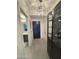 Stylish entryway featuring modern light fixture, display cabinet, and access to the bathroom at 7120 E Kierland Blvd # 404, Scottsdale, AZ 85254