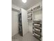 A space-saving laundry room with stacked washer and dryer and open shelving for storage at 7120 E Kierland Blvd # 404, Scottsdale, AZ 85254