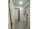 This is a laundry room with a stackable washer and dryer and open shelving storage at 7120 E Kierland Blvd # 404, Scottsdale, AZ 85254
