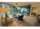 Bright living room with modern furniture and floor-to-ceiling windows with green views at 7120 E Kierland Blvd # 404, Scottsdale, AZ 85254
