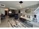 A modern living room with a view of a kitchen, designer lighting, modern furnishings, and accent wall at 7120 E Kierland Blvd # 404, Scottsdale, AZ 85254