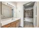 Bright bathroom featuring a single sink vanity and a tub with shower at 7575 E Indian Bend Rd # 1005, Scottsdale, AZ 85250