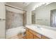 Bathroom with single sink vanity, bathtub, and tiled shower at 7575 E Indian Bend Rd # 1005, Scottsdale, AZ 85250