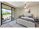 Bedroom featuring a ceiling fan, neutral walls, and a sliding glass door to a patio at 7575 E Indian Bend Rd # 1005, Scottsdale, AZ 85250