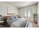 Cozy bedroom featuring a neutral color palette, artwork, and a window at 7575 E Indian Bend Rd # 1005, Scottsdale, AZ 85250
