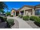 Inviting single-story home with desert landscaping, a tiled roof, and a walkway leading to the front door at 7575 E Indian Bend Rd # 1005, Scottsdale, AZ 85250