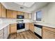 Kitchen with wooden cabinets, laminate countertops, and wood-look flooring at 7575 E Indian Bend Rd # 1005, Scottsdale, AZ 85250