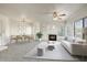Bright living room with a fireplace, a ceiling fan, large windows, and an adjacent dining area at 7575 E Indian Bend Rd # 1005, Scottsdale, AZ 85250