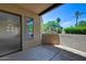 Outdoor patio space with desert landscaping and partial view of a living room at 7575 E Indian Bend Rd # 1005, Scottsdale, AZ 85250
