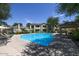 Community pool surrounded by lounge chairs and shade at 7575 E Indian Bend Rd # 1005, Scottsdale, AZ 85250