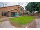 Expansive backyard includes brick paving, green grass, and string lights at 760 N Swallow Ln, Gilbert, AZ 85234