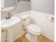 Bathroom with white toilet, vanity and wainscoting at 760 N Swallow Ln, Gilbert, AZ 85234
