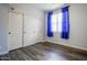 Bright bedroom features wood-look floors, large closet, and a sun-filled window at 760 N Swallow Ln, Gilbert, AZ 85234