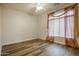 Empty bedroom with wood-look floors, neutral paint, and decorative window coverings at 760 N Swallow Ln, Gilbert, AZ 85234