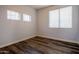 Neutral bedroom with wood-look floors and bright window views at 760 N Swallow Ln, Gilbert, AZ 85234