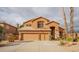 Inviting home with a three-car garage, neutral stucco and stacked stone accents at 760 N Swallow Ln, Gilbert, AZ 85234