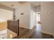 Second floor hallway with wood floors and wooden railing at 760 N Swallow Ln, Gilbert, AZ 85234