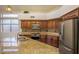 Kitchen with wood cabinets, granite countertops and stainless steel appliances at 760 N Swallow Ln, Gilbert, AZ 85234
