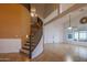 Spacious living room with a spiral staircase, high ceilings, and natural light at 760 N Swallow Ln, Gilbert, AZ 85234
