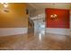 Open-concept living space with tile floors and a dramatic, red accent wall at 760 N Swallow Ln, Gilbert, AZ 85234