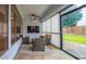 Enclosed sunroom featuring tile flooring, a ceiling fan, and backyard access at 760 N Swallow Ln, Gilbert, AZ 85234