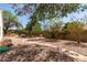 Large backyard featuring stone pathways, mature trees, and desert landscaping at 804 N 46Th St, Mesa, AZ 85205