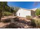 Secluded backyard featuring desert landscaping, a stone walkway, and the exterior of the house at 804 N 46Th St, Mesa, AZ 85205
