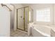 Bathroom showcasing a shower and garden tub with gold-framed glass door at 804 N 46Th St, Mesa, AZ 85205
