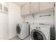Bright laundry room features a washer, dryer and storage cabinets at 804 N 46Th St, Mesa, AZ 85205