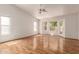 Bright living room with hardwood floors, multiple windows, and a door to the backyard at 804 N 46Th St, Mesa, AZ 85205