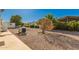 Gravel backyard is landscaped with trees, shrubs, and offers a low-maintenance outdoor space at 8103 E Southern Ave # 69, Mesa, AZ 85209