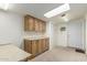 This basement features storage cabinets, a countertop, and an exterior door for functionality at 8103 E Southern Ave # 69, Mesa, AZ 85209