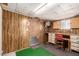 This basement features wood paneling, built in storage, and a working space with desk at 8103 E Southern Ave # 69, Mesa, AZ 85209