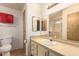 Bathroom with a sink, a toilet, vanity and red medicine cabinet at 8103 E Southern Ave # 69, Mesa, AZ 85209