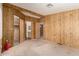Bedroom showcasing wood paneling, neutral carpet and a closet with a mirrored door at 8103 E Southern Ave # 69, Mesa, AZ 85209